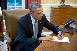 President Barack Obama signs a letter to a Cuban letter writer, in the Oval Office, March 14, 2016. (Official White House Photo by Pete Souza) This official White House photograph is being made available only for publication by news organizations and/or for personal use printing by the subject(s) of the photograph. The photograph may not be manipulated in any way and may not be used in commercial or political materials, advertisements, emails, products, promotions that in any way suggests approval or endorsement of the President, the First Family, or the White House.