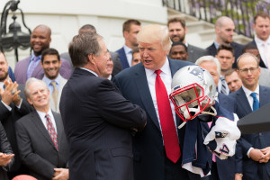Donald_Trump_with_jersey,_helmet_and_football_of_New_England_Patriots