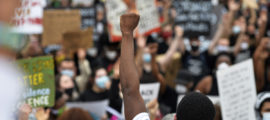 Protesters rally on the steps of the State House